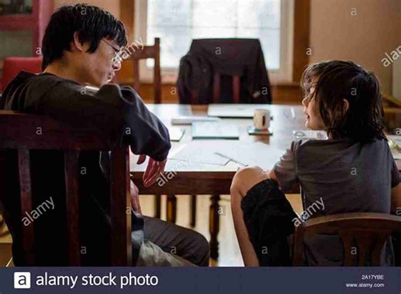 A Father And Son Sitting At A Table, Discussing And Setting Goals Together. 41 Deposits: Crucial Conversations For Fathers And Sons