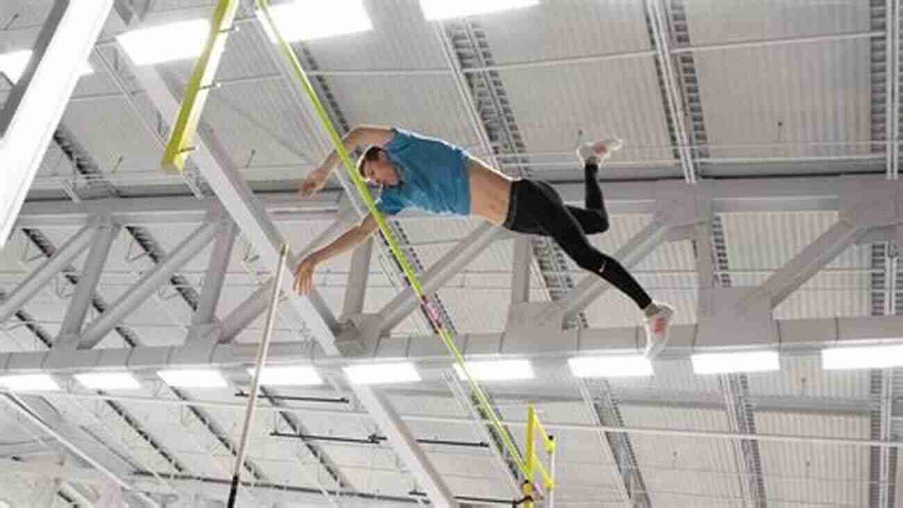 Male Pole Vaulter Reaching New Heights, Suspended In Mid Air As If Frozen In Time. Winning Jumps And Pole Vault